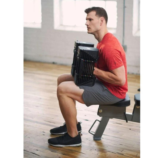 Powerblock Pro 50 Adjustable Dumbbells - Model Sitting on Bench