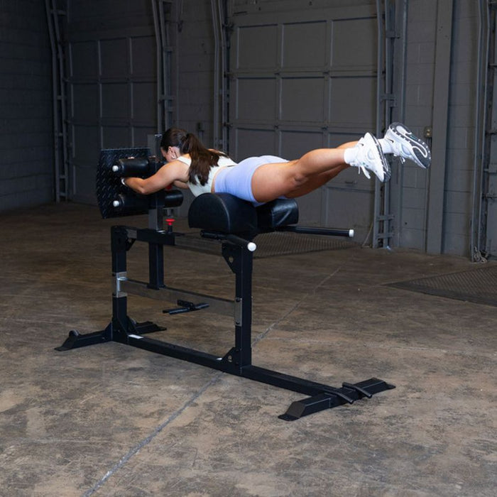 Body-Solid Pro Clubline Glute Ham Developer SGH500B demo woman glute raise