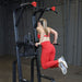 Body-Solid Pro Clubline Vertical Knee Raise SVKR1000B demo woman dip