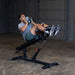Body-Solid SAB500B Pro Clubline Commercial Ab Bench - Model Doing Weight Sit Ups with Med Ball
