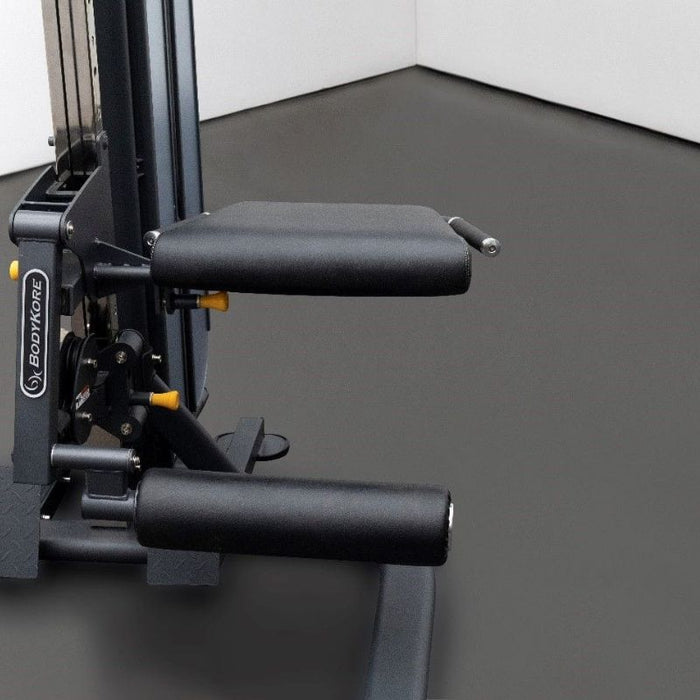 BodyKore Universal Leg Ext/Curl Seat MX1175 mounted on functional trainer