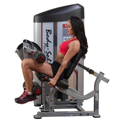 Woman doing seated machine leg extensions exercise
