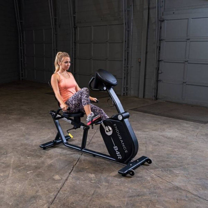 Endurance by Body-Solid Recumbent Bike B4RB Front Side View With Female Model