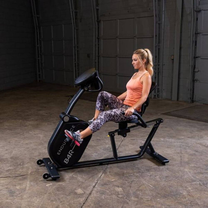 Endurance by Body-Solid Recumbent Bike B4RB Side View With Female Model